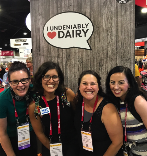 Staff smiling at the dairy council booth